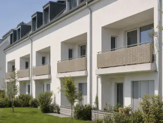 Weite Ansicht der Hausfassade mit mehreren gleichartigen Balkongeländern
