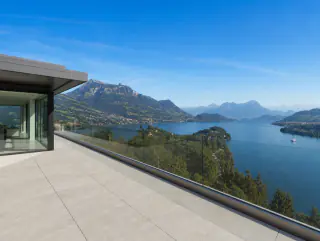 Weite Ansicht der Terrassenkante mit Glasbrüstung und Bergpanorama